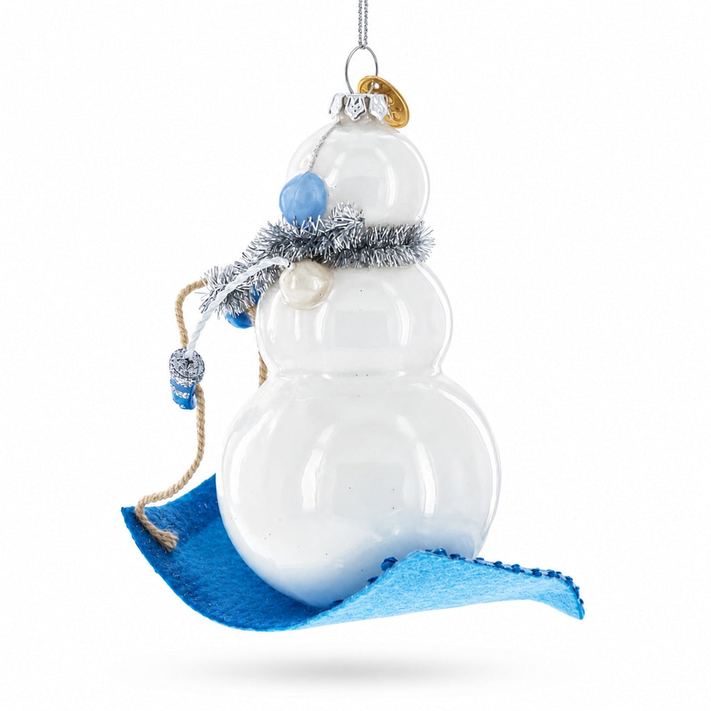 Snowman Riding a Sled Glass Christmas Ornament