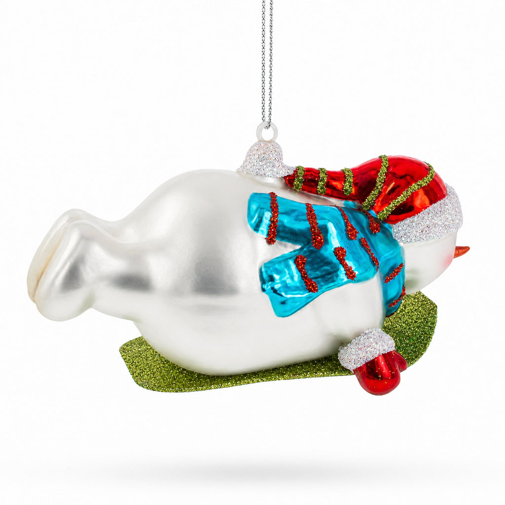 Snowman Gleefully Riding a Sled Glass Christmas Ornament