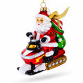 Santa Delivering Gifts on a Snowmobile Glass Christmas Ornament